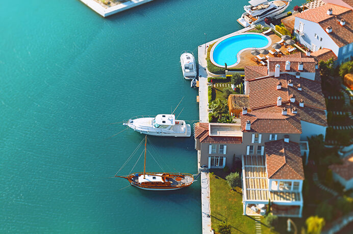 2 boats docked in the bay outside a private home | Alliant Private Client