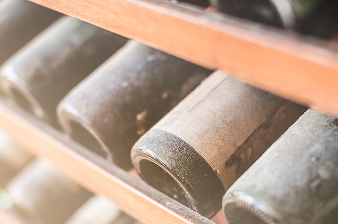 Close up of dusty wine collection | Alliant Private Client