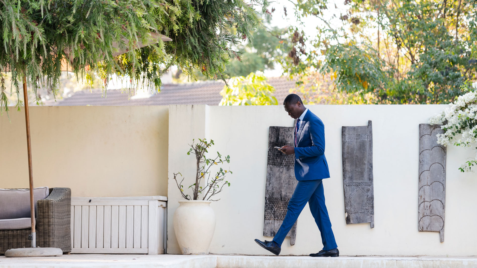 Man in suit conducting business on cell phone | Alliant Private Client