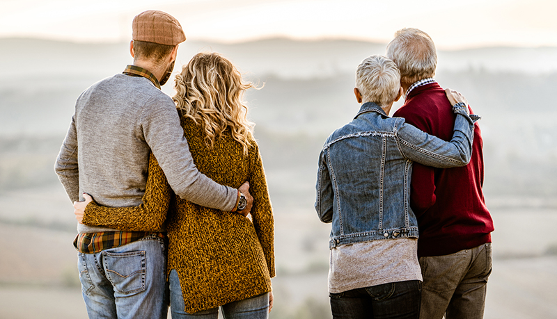 Parents and adult child couples, both embracing spouse | Alliant Private Client