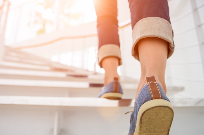 Woman's feet wearing denim boat shoes walking up stairs outside | Alliant Private Client
