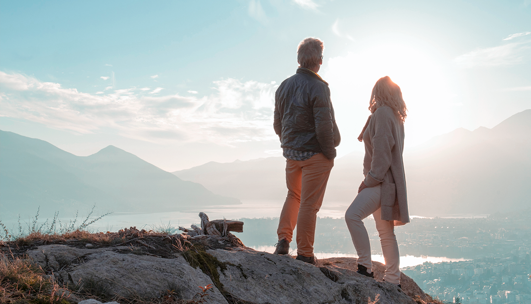 Couple hiking overlooking community