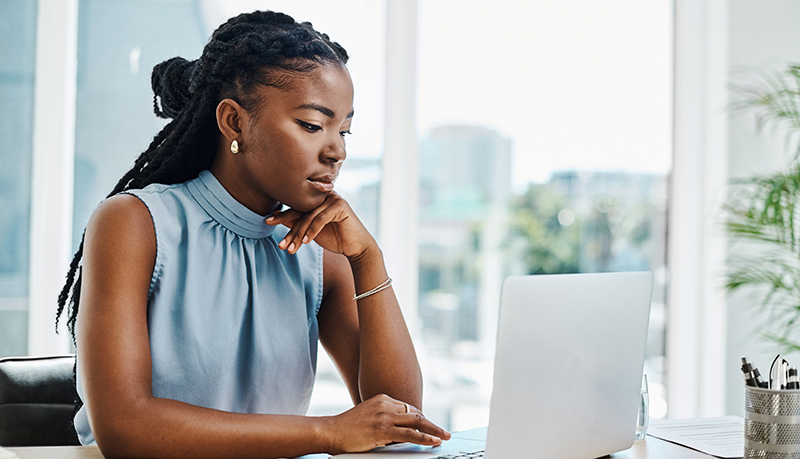 Business women working on her laptop at her office | Alliant Private Client