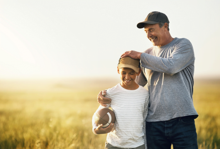 Grandfather and grandson playing football | Alliant Private Client