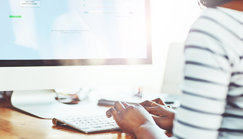 Women working at her desk on her computer | Alliant Private Client